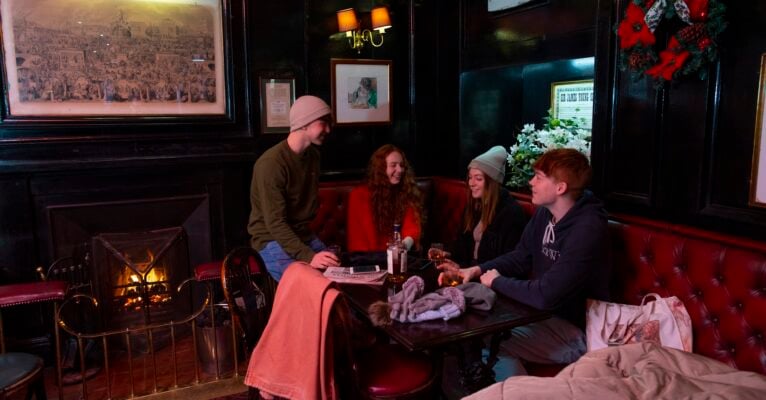Cosy bar with couples and fire laughing