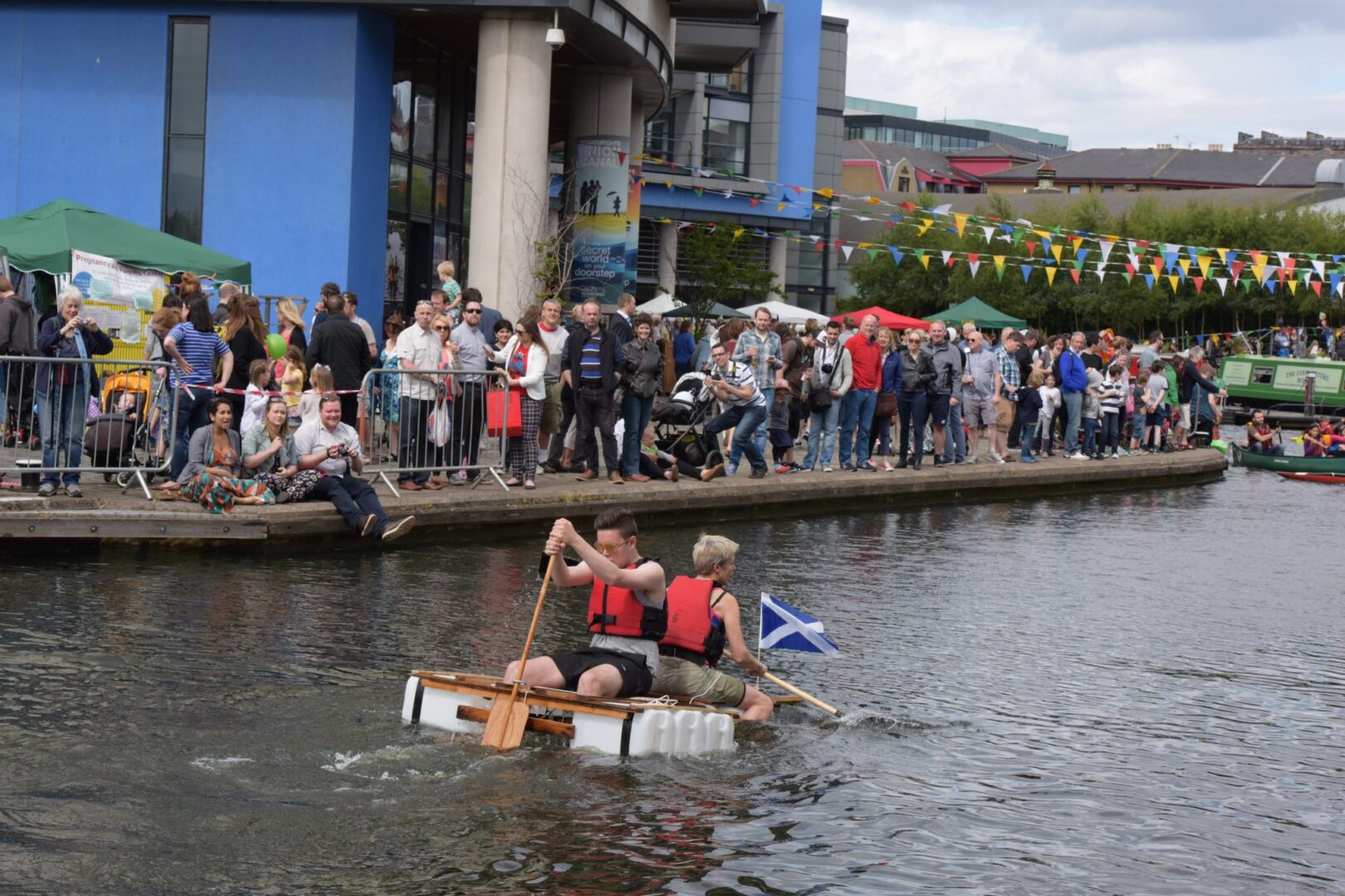 A raft being paddled along the Union Canal during the Edinburgh Canal Festival