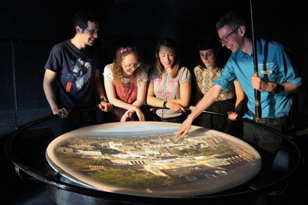 A group of people looking at a table with a projected image of Edinburgh, called at Camera Obscura., Camera Obscura & World of Illusions, Edinburgh