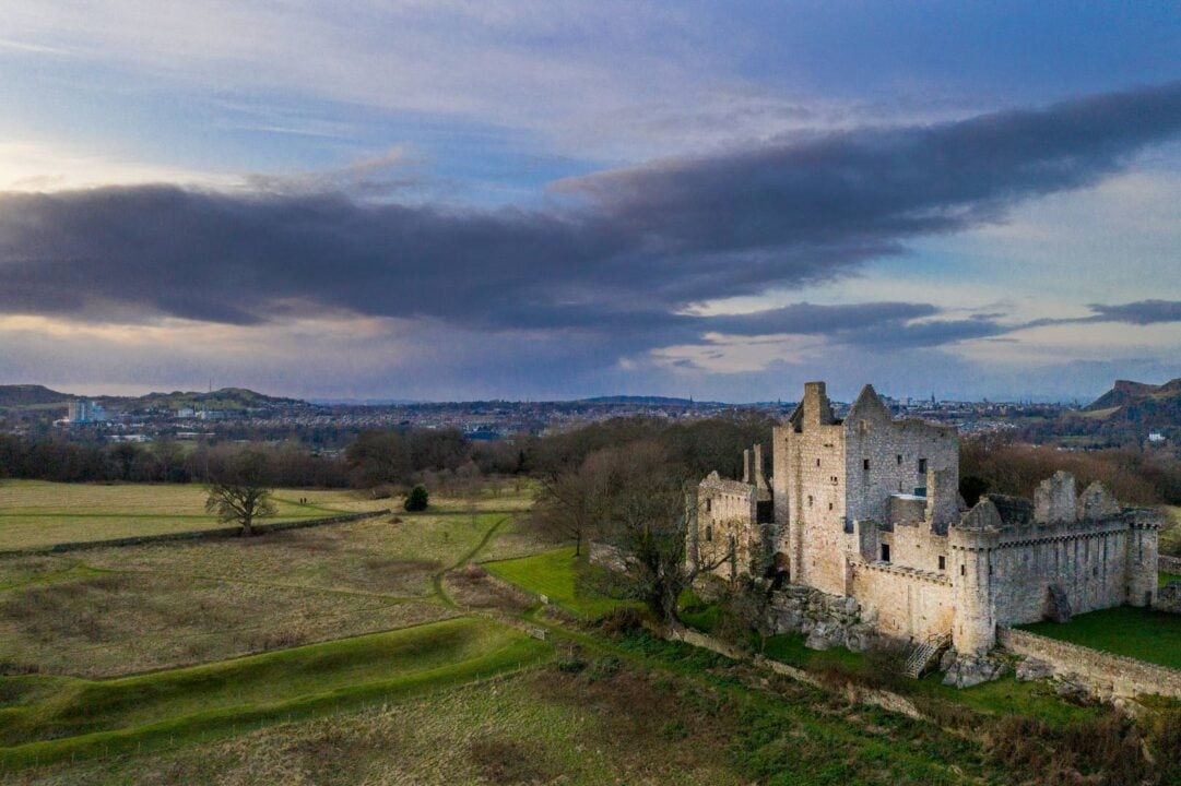 Image of a castle with surrounding landscape.