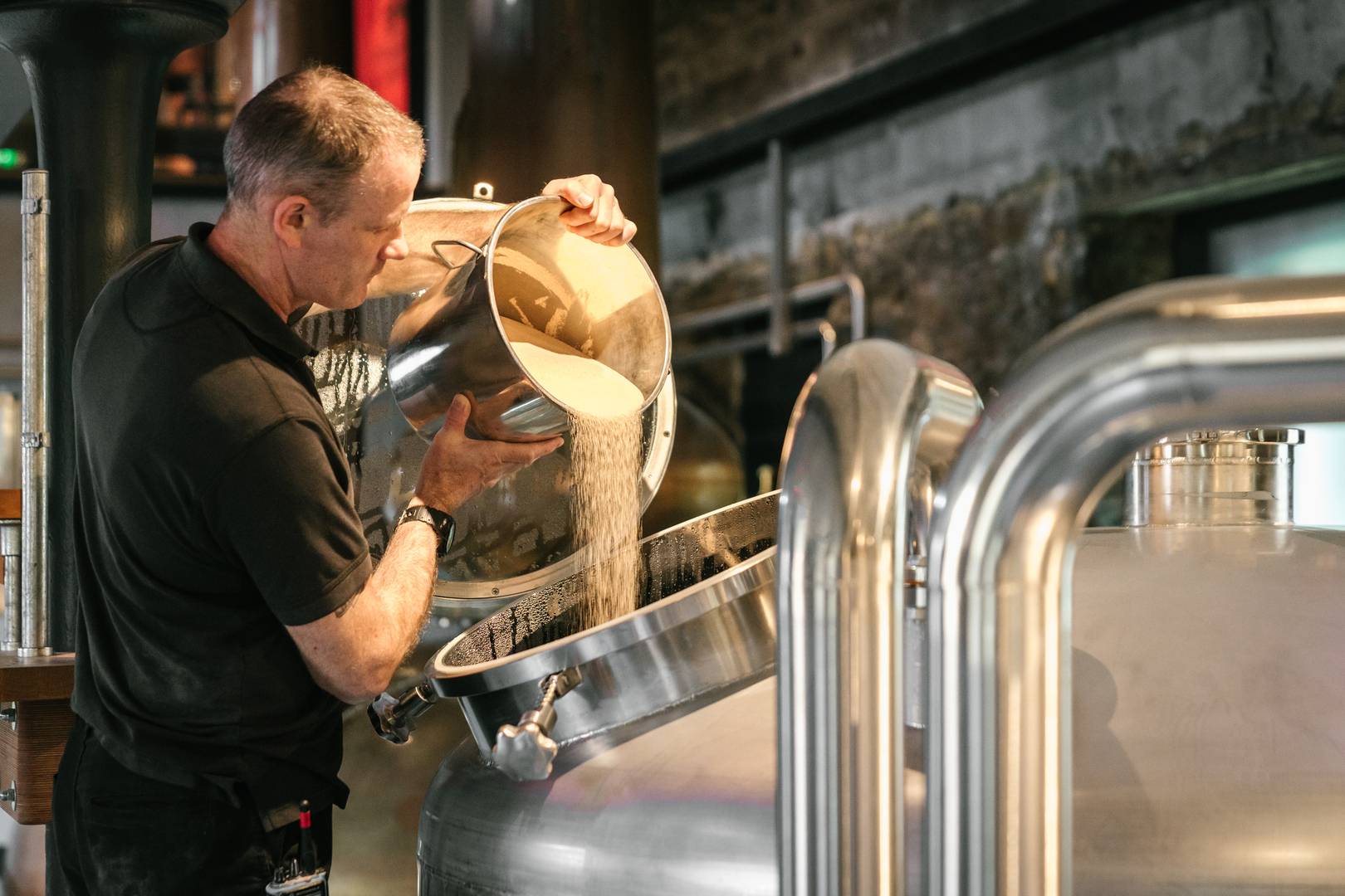 Rub shoulders with our distillers busy making our whisky.