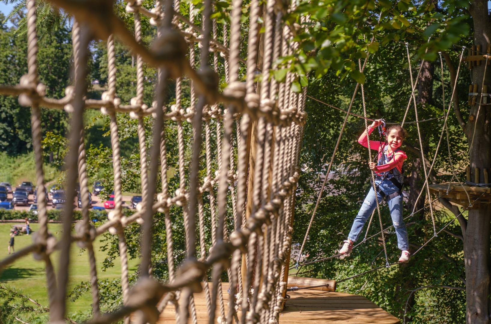 Girl on ropes course at Go Ape within Dalkeith Country Park, Dalkeith Country Park 