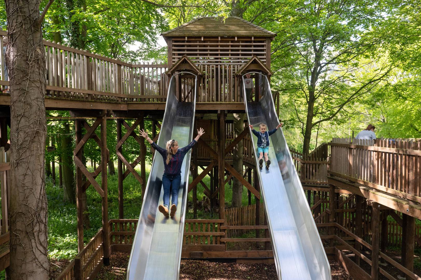 Mum and son going down slides at Fort Douglas - located at Dalkeith Country Park, Dalkeith Country Park