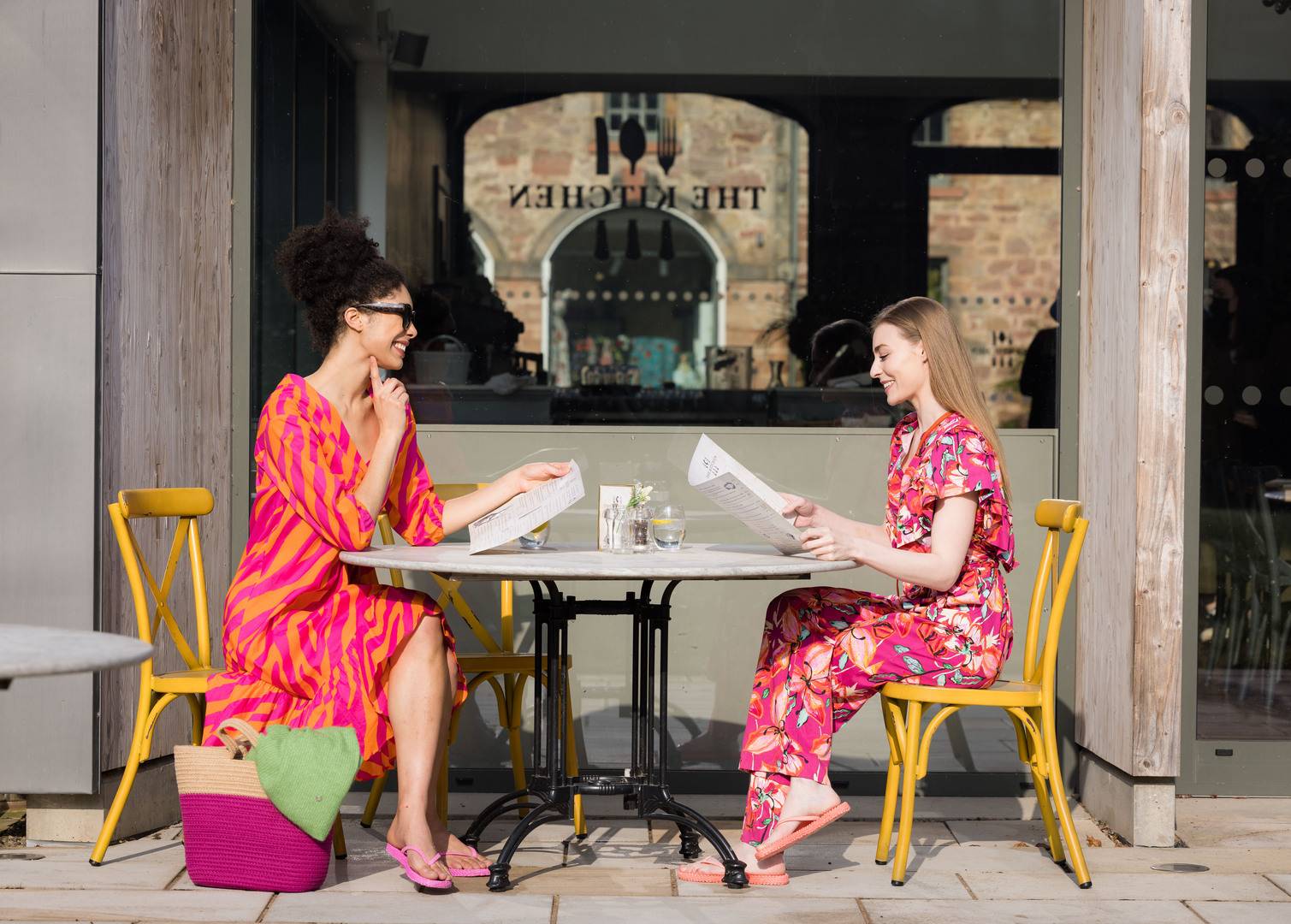 Two woman sitting down for lunch at The Kitchen located within Restoration Yard,© Restoration Yard