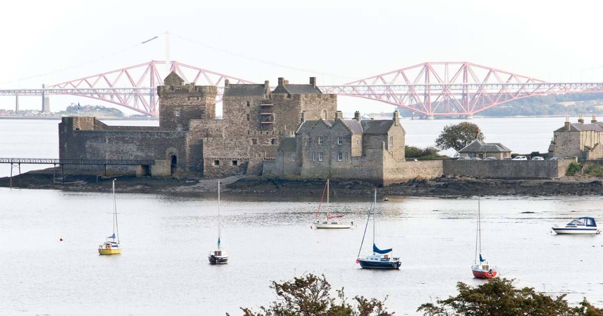 Image of castle next to a body of water.