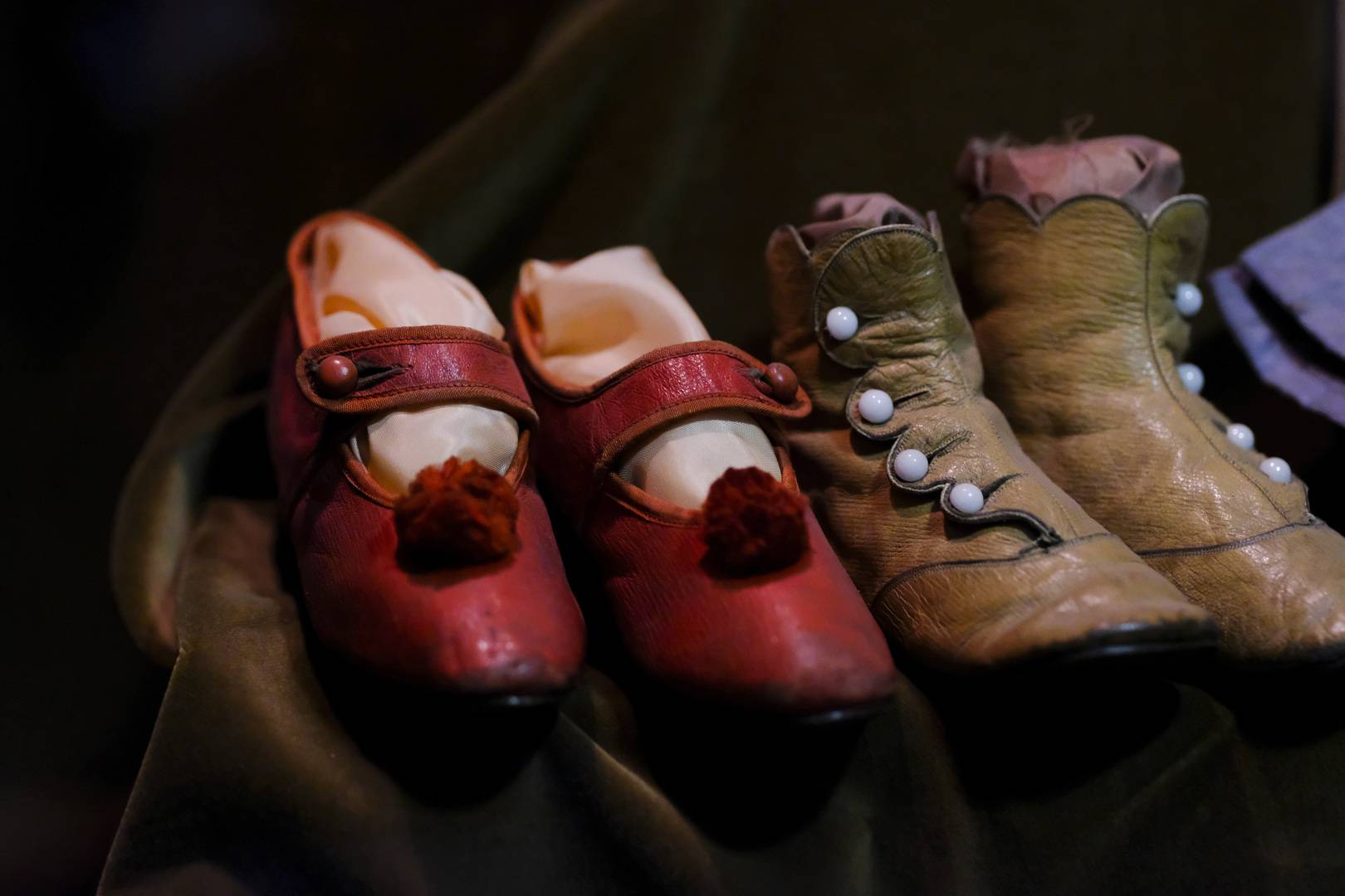 Two pairs of children's shoes placed together on display in Museum of Childhood
