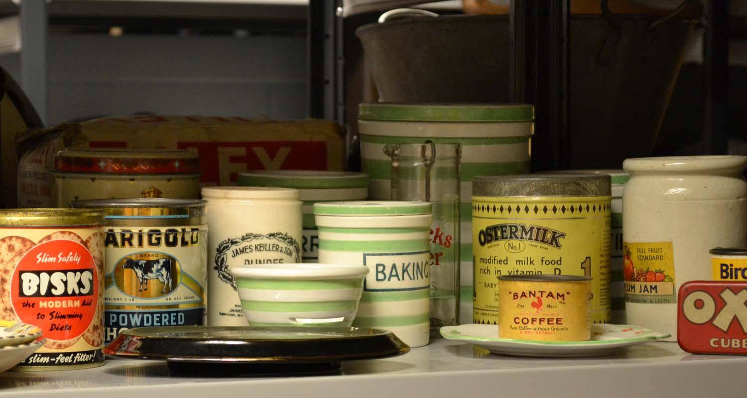 Shelf filled with various tins and baking items from over decades.