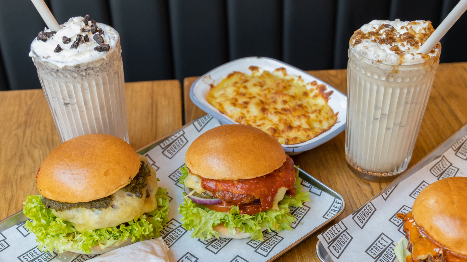 Oreo milkshake and Sticky Toffee Pudding milkshake alongside mac and cheese, O.G.R beef burger and Where's The Lamb burger on tray with seasoned Koffmann's Fries.