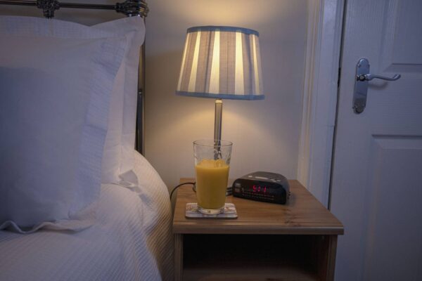 Bedside Table with a glass of orange juice