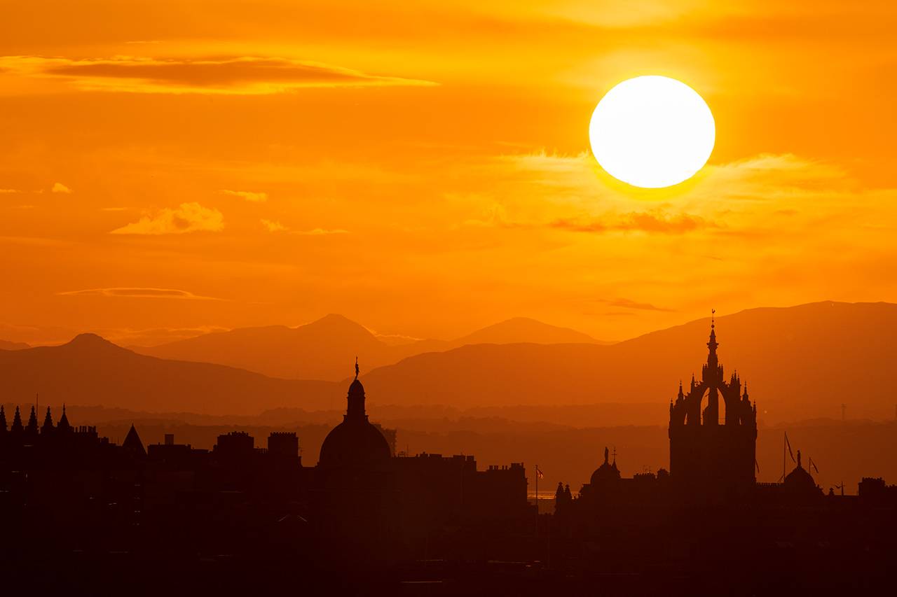 Sunset over the city from a long viewpoint outside the city, Tom Duffin Photography