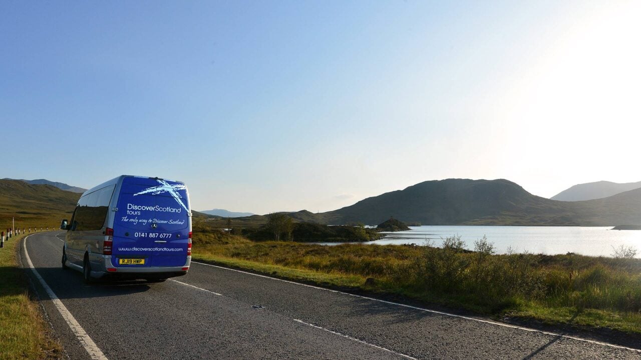 Image of Discover Scotland Tours van driving through scenic views,© Discover Scotland Tours