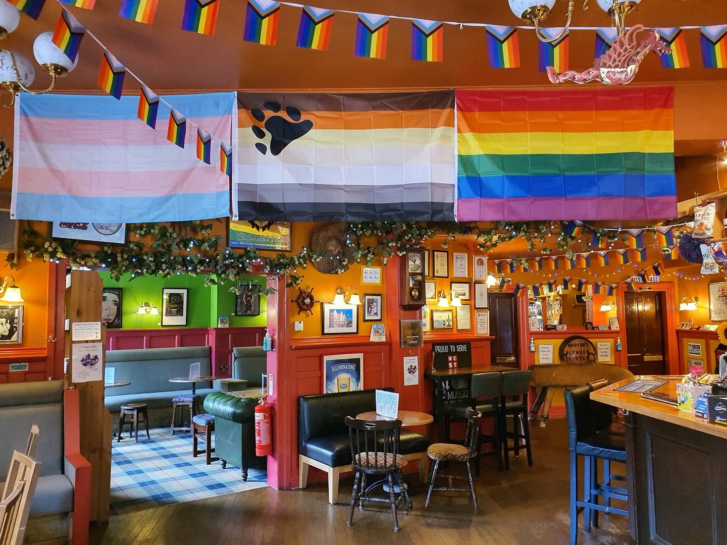 The interior of The Regent is colourfully decorated with Pride flags.