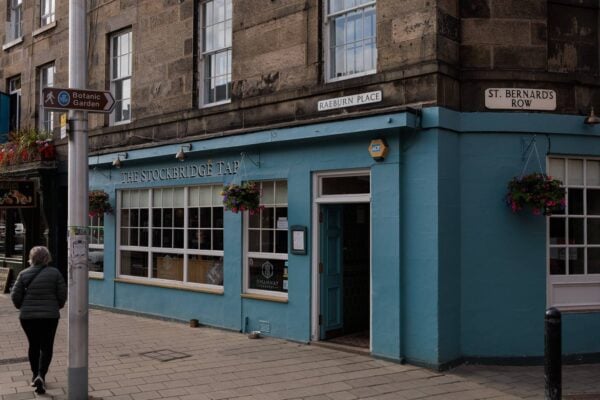 The Stockbridge Tap exterior - a blue building with flower hanging outside.