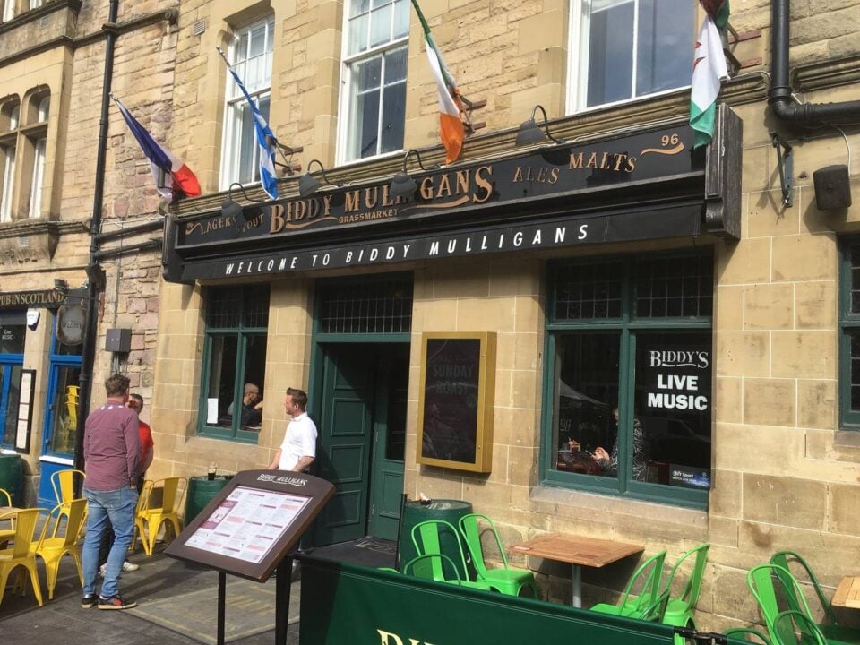 Image of entrance to Biddy Mulligans on the grassmarket - different countries flags hand outside