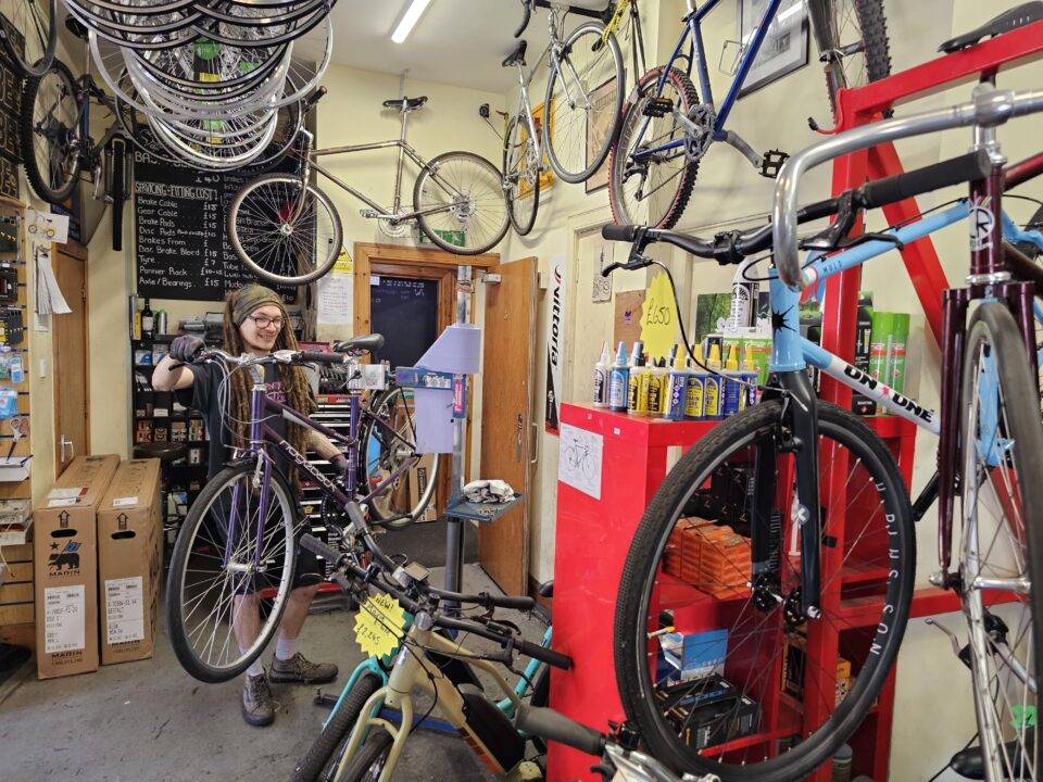 Man holding bike in bike shop