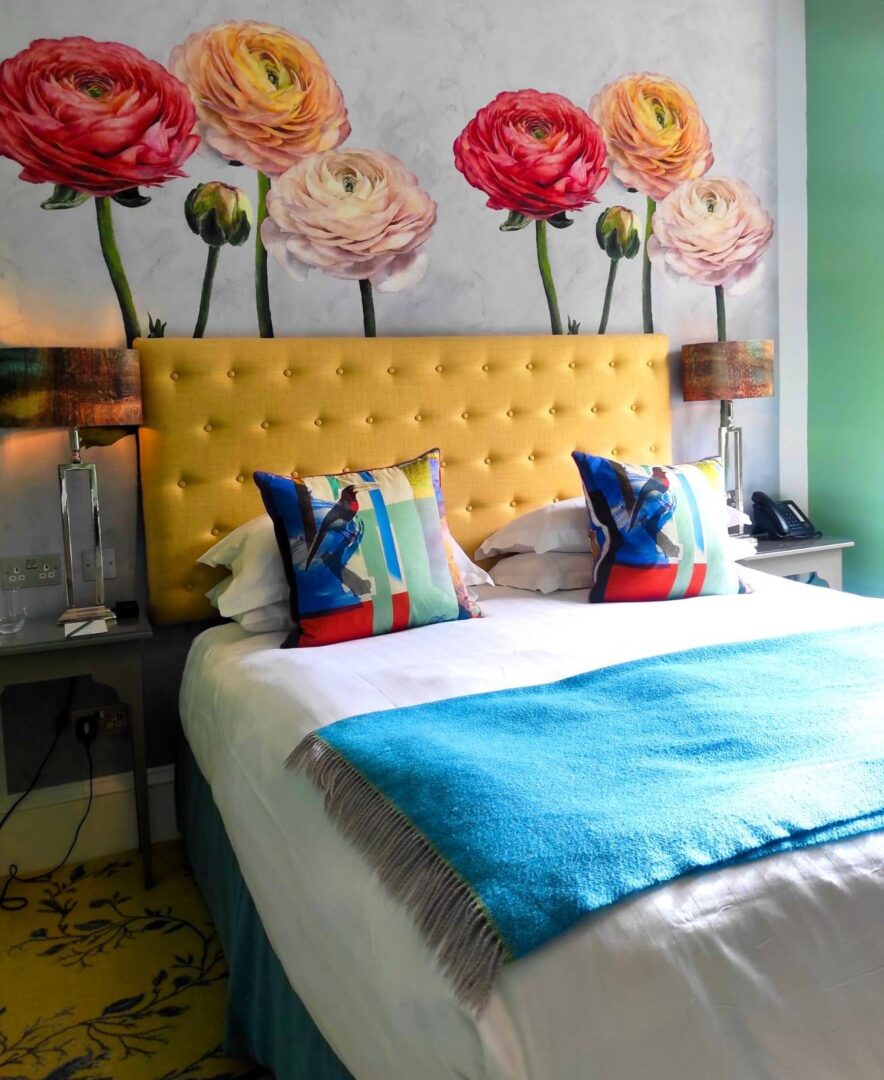 Image of mustard coloured bedhead in front of wall with enormous flower mural