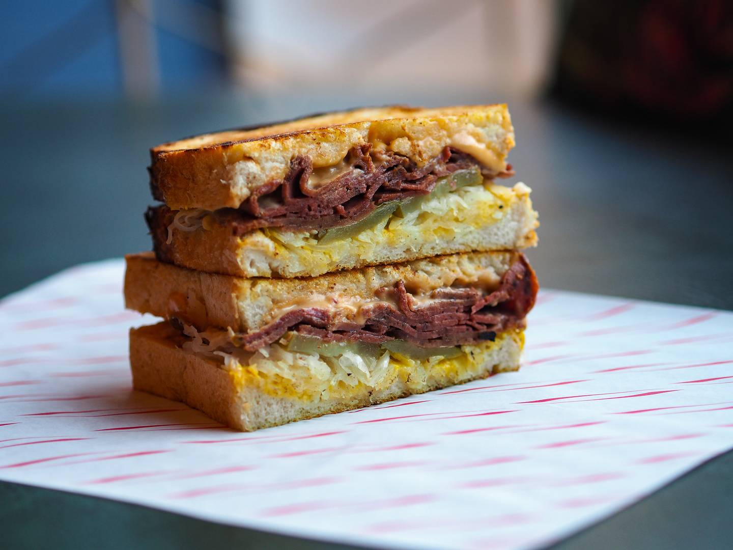 Vegan Reuben sandwich featuring FacePlant's own vegan cheese and pastrami, sauerkraut, pickles, mustard