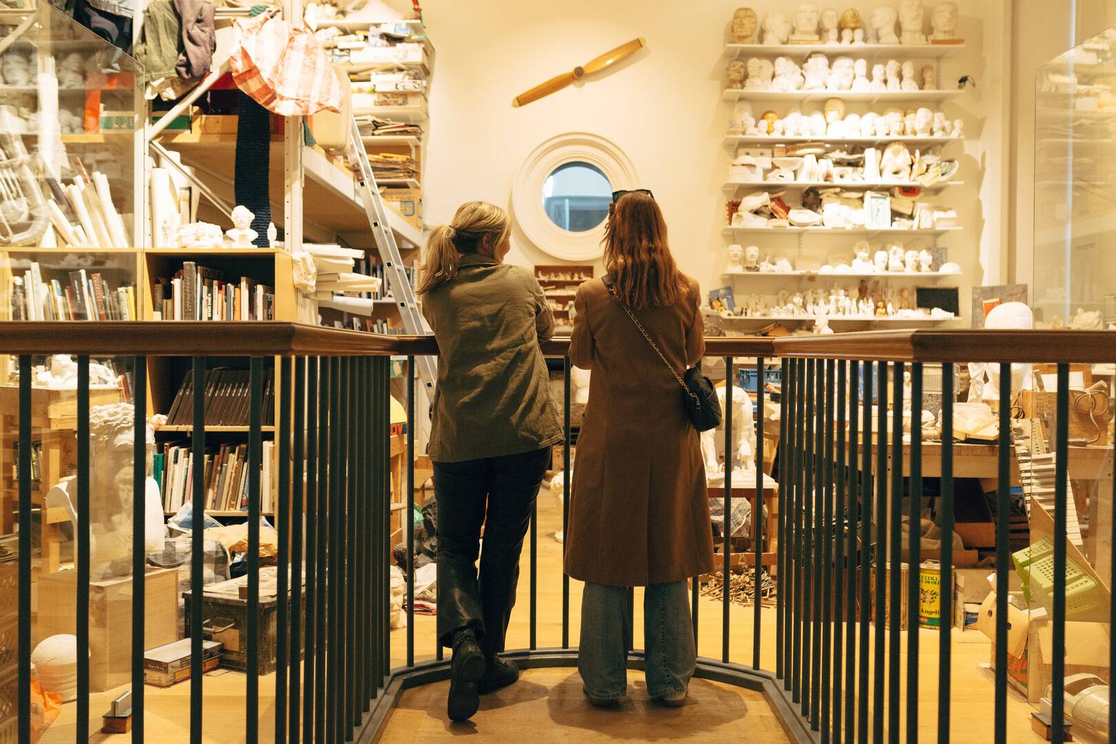 Two women look at a recreation of the studio of artist Eduardo Paolozzi,© National Galleries of Scotland