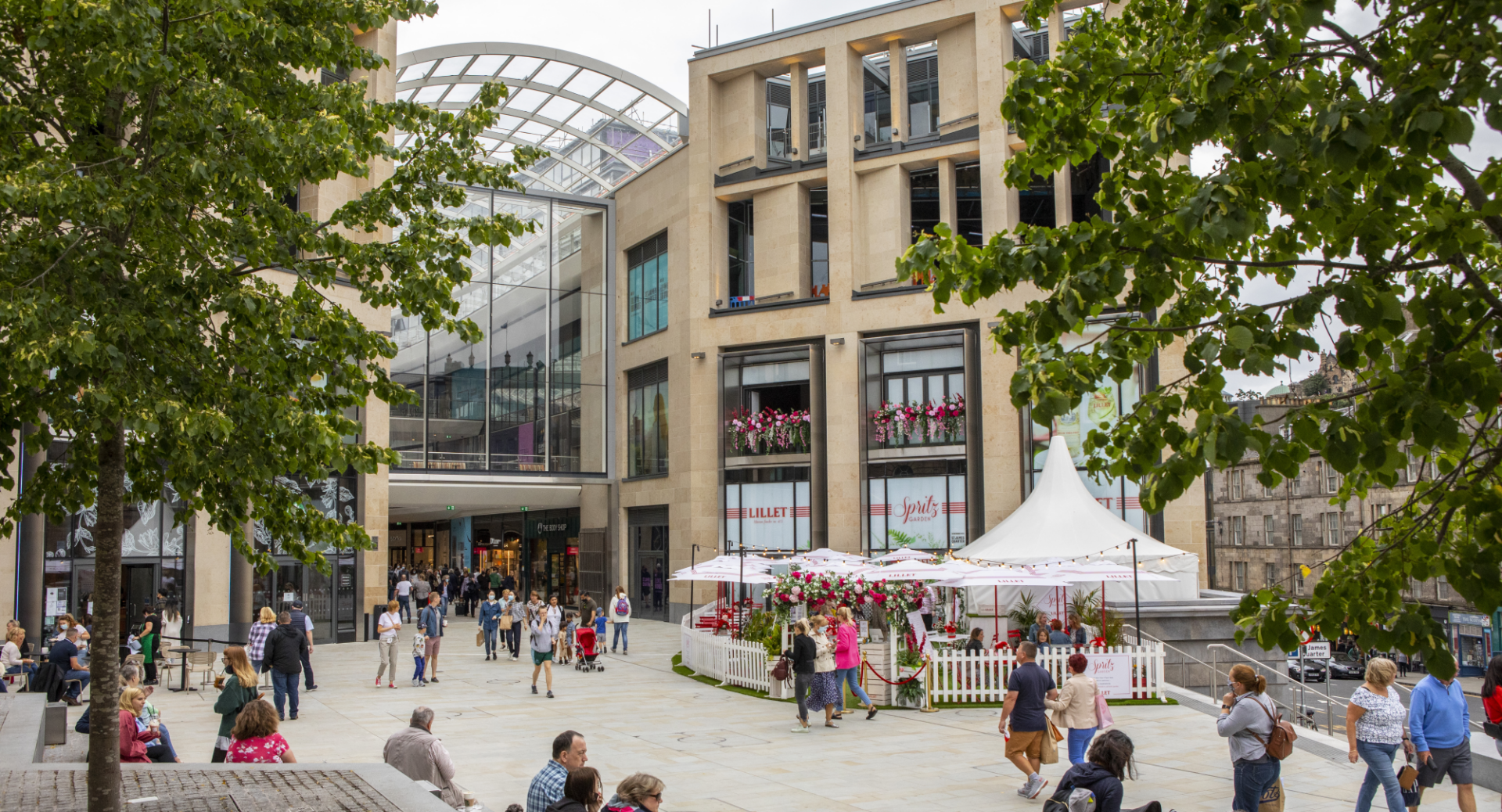 St James Quarter, external shot with people sitting relaxing outside of the mall.