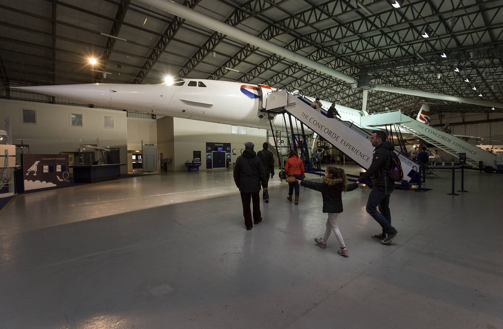 Visitors walk under the Concorde aircraft on display indoors at the National Museum of Flight.,Image © Ruth Armstrong Photography