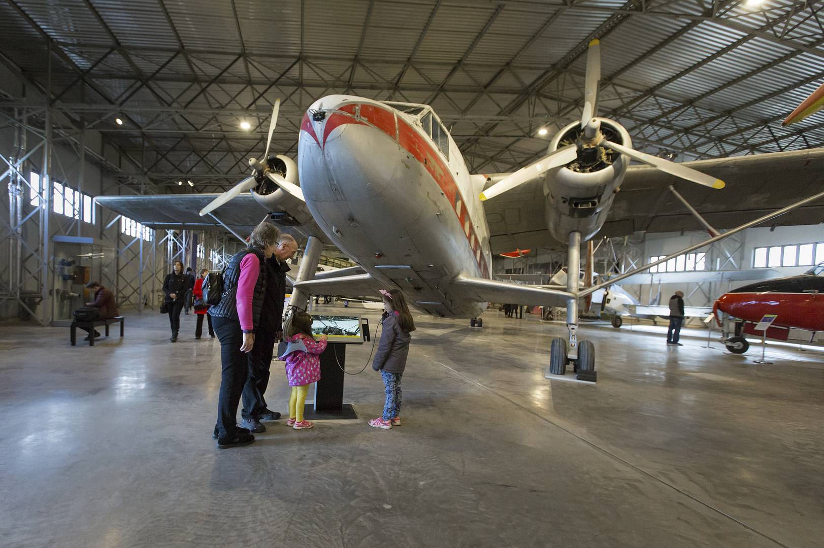 A family look at an interactive AV beside an aircraft in the Civil Aviation hangar at the National Museum of Flight , Image © Ruth Armstrong Photography