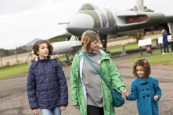 A family of one adult and two children in front of the Vulcan aircraft at the National Museum of Flight , Image © Ruth Armstrong Photography