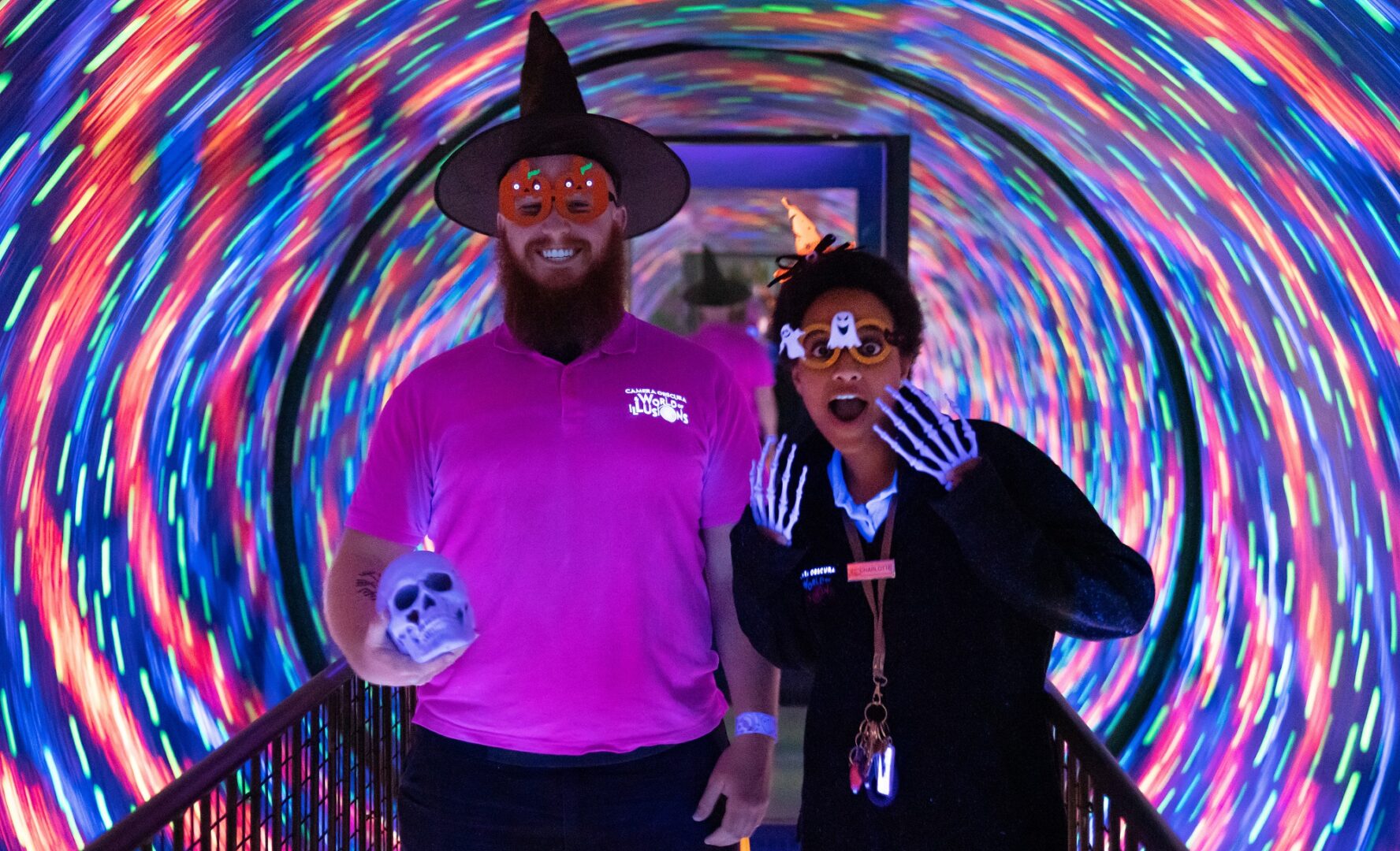 2 people dressed in Halloween outfits in the maze at camera obscura