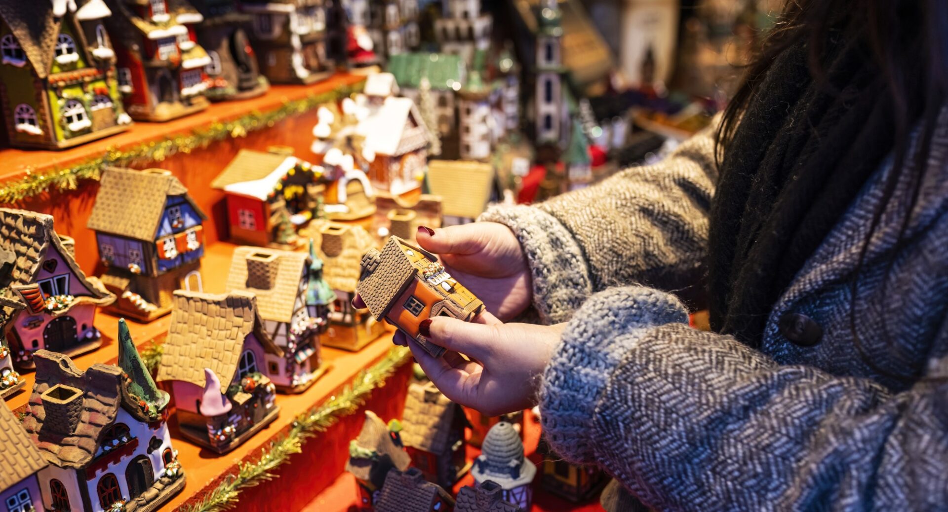 Edinburgh Christmas Market - lady's hand holding small house ornament.