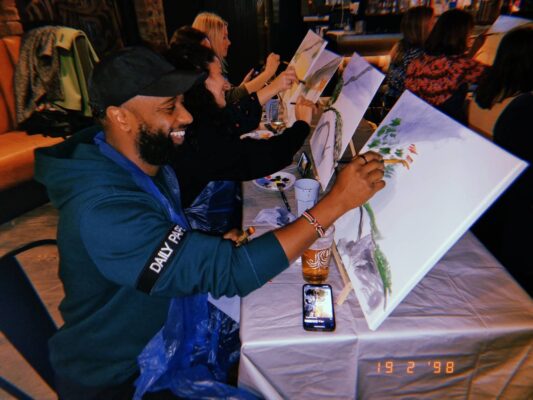 Group of people painting with drinks