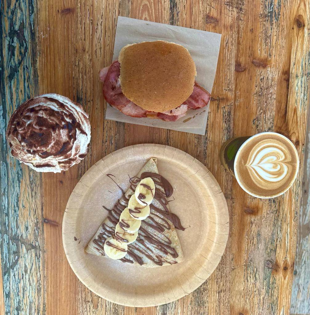 Image of coffee, desserts and bacon roll spread