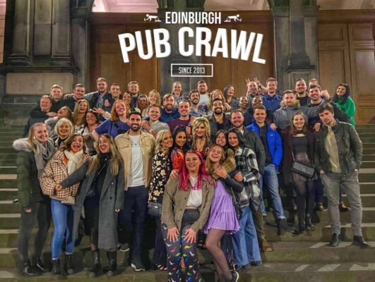 Large group of happy people taking part in Edinburgh Pub Crawl