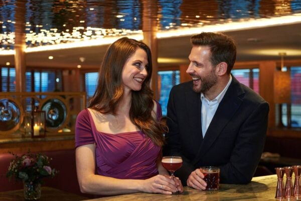 Couple at bar with cocktails