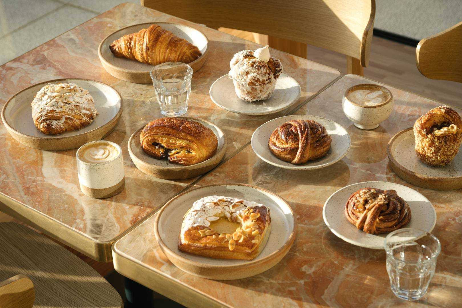 A table abundantly full of  crafted pastries and masterful coffee served in our own crafted pottery, Patina Edinburgh