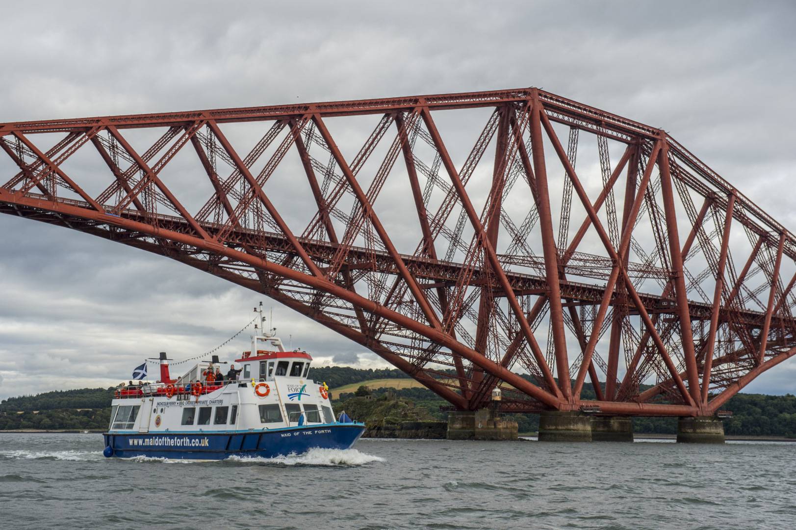 The Maid of the Forth sailing in front of the Forth Rail Bridge.