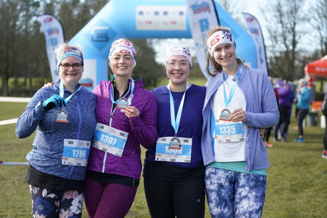 A group of 4 ladies with their Finishers Medals at end of MoRun