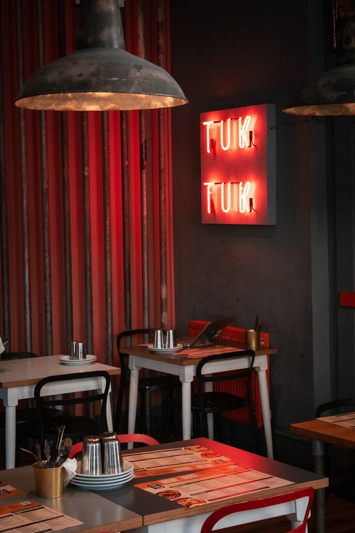 Tuk Tuk tables and neon sign