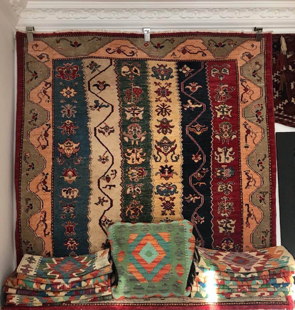 Patterned rug hung up in shop display