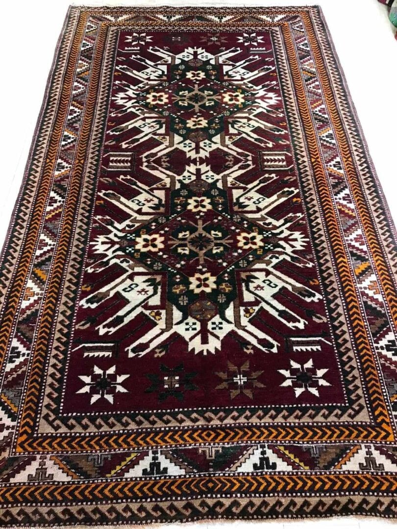 Red, green and cream patterned rug