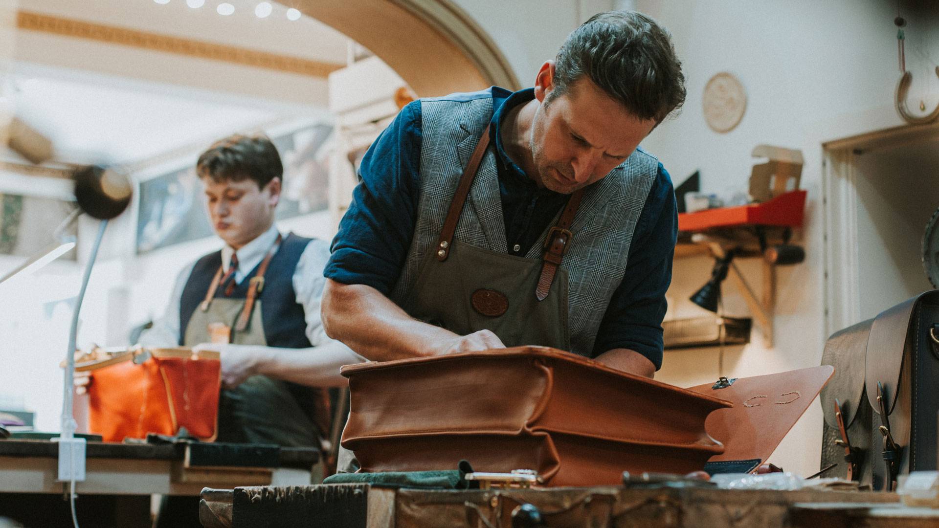 Simon Harvey Potts, owner and Master craftsman making an Officers Briefcase in London tan colour.