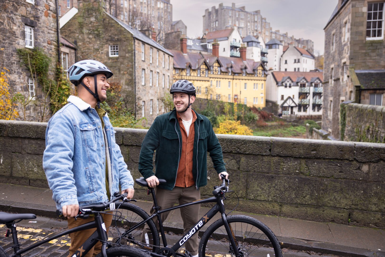 Two men standing with bikes at Dean Village