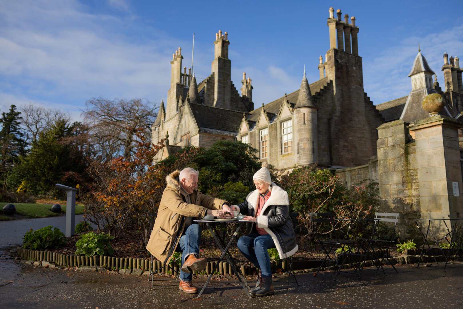 Lauriston Castle, couple sitting drinking tea in front of Castle. 