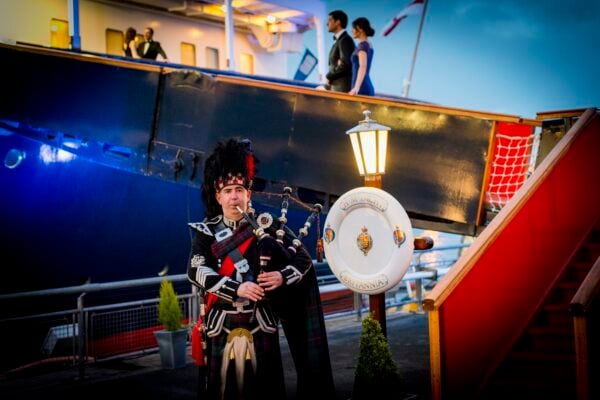 Piper welcoming the people attending a Burns Supper on the Royal Yacht Britannia