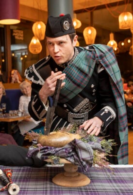 Piper Addressing the Haggis at the Scottish Cafe Burns Night