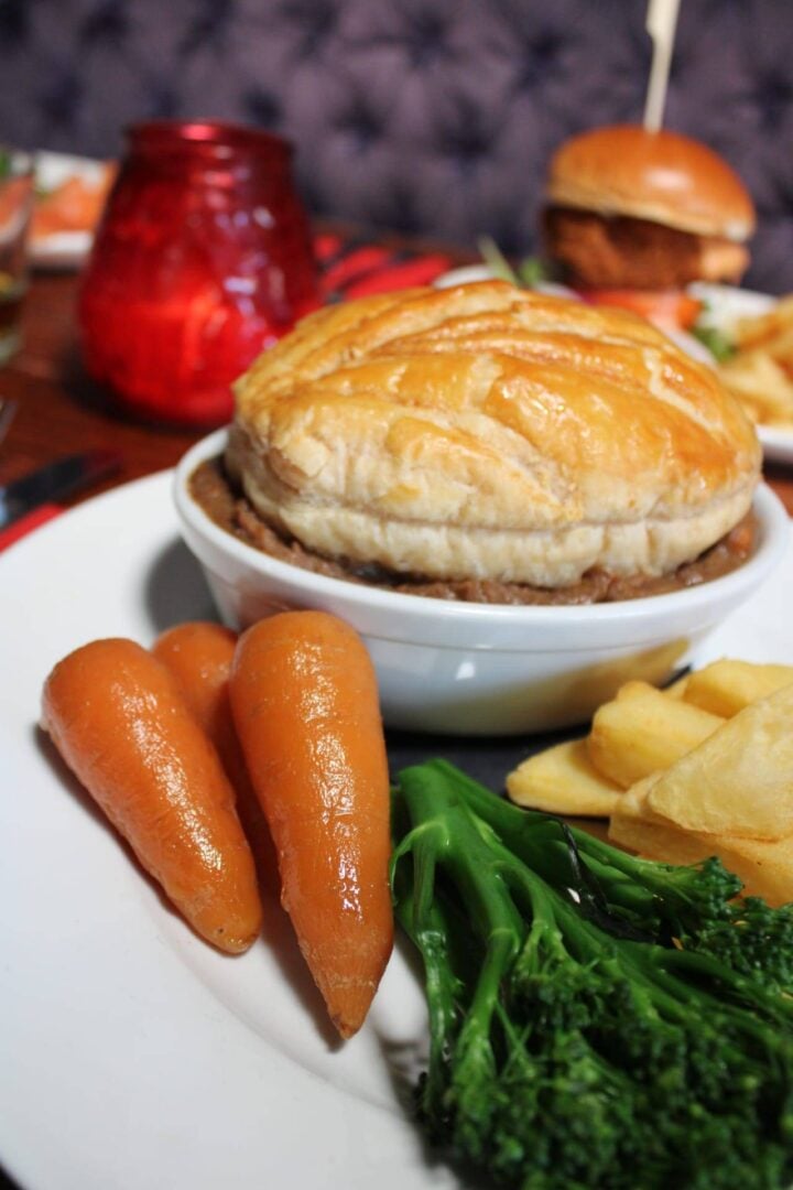 Steak pie with chips and carrots