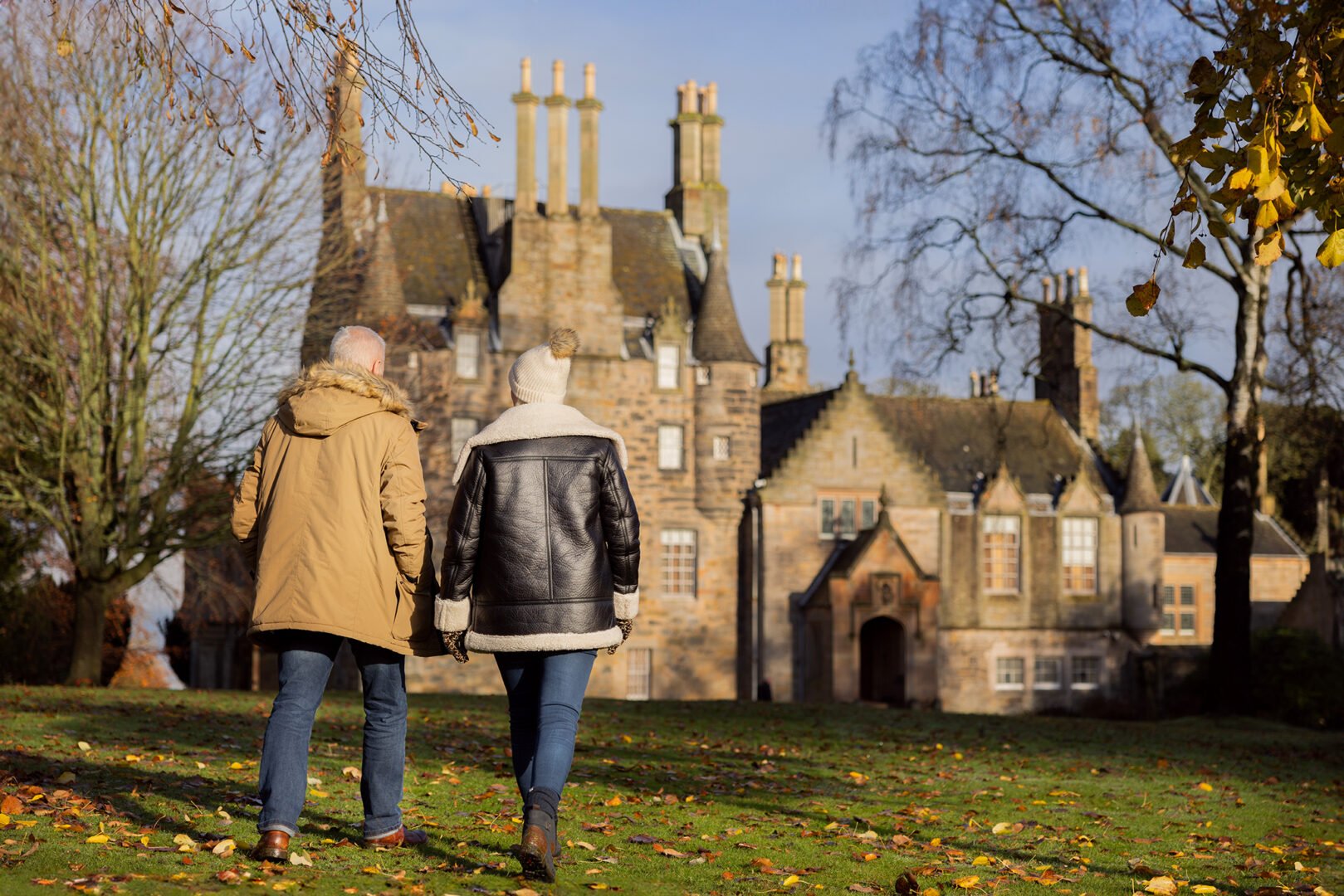 Couple walking with Lauriston Castle in back ground