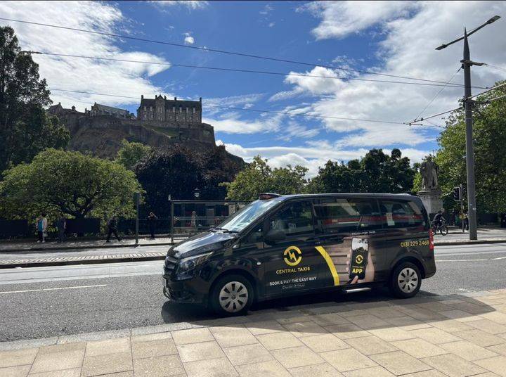 A Central Taxi parked on Princes Street with Edinburgh Castle in background, Central Taxis