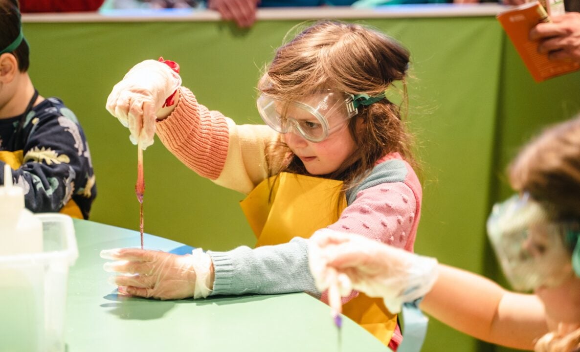 Girl doing experiment at Edinburgh Science Festival in the City Art Centre