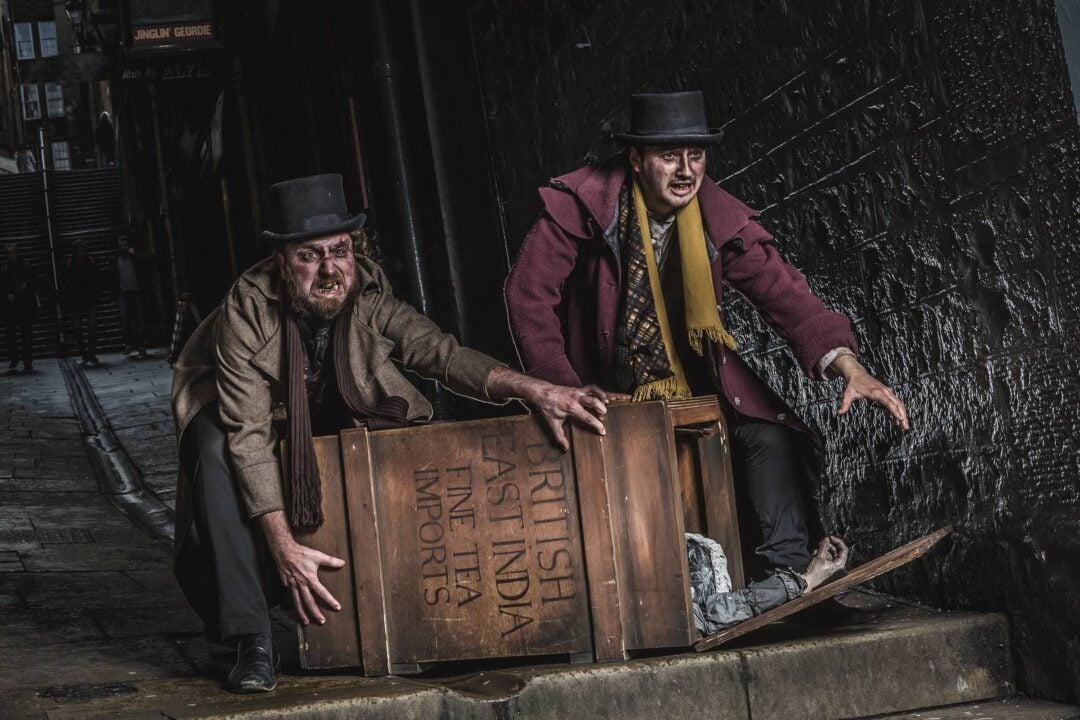 Image of Burke and Hare pushing a tea chest uphill
