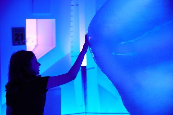 Girl touching large block of ice