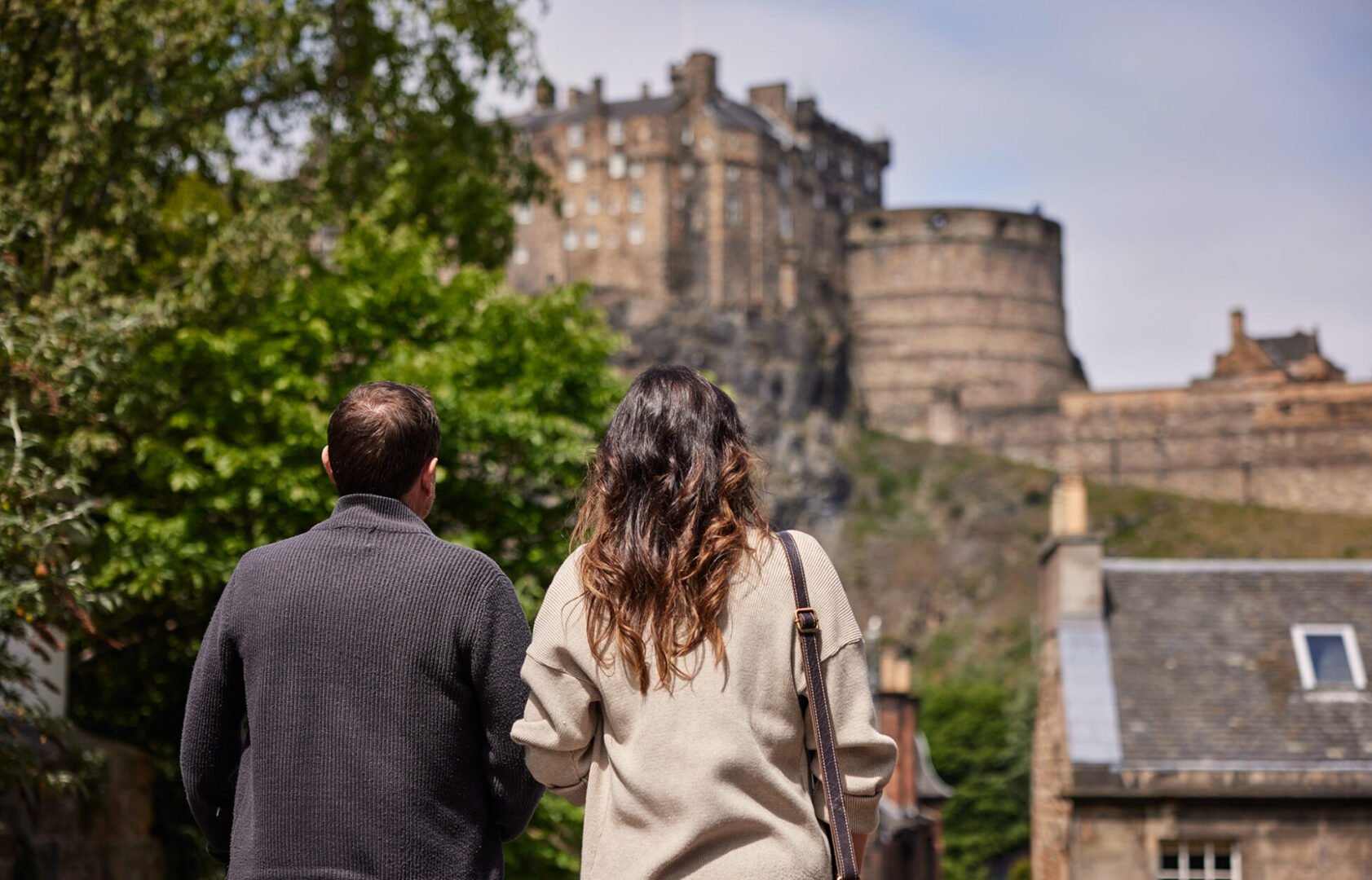 Couple walking down the Vennel stairs with Edinburgh Castle in the background
